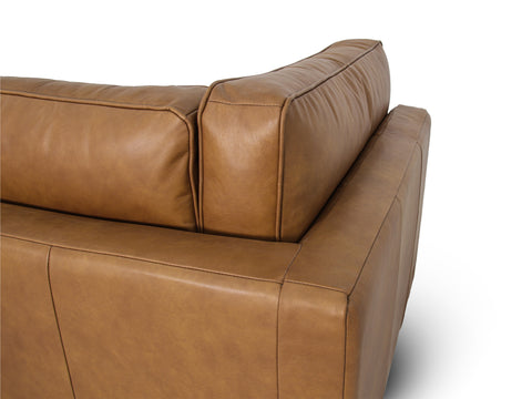 Eleganza Tan Distressed Leather 3 Seater Sofa showcasing plush cushions and rich leather texture.