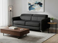 Elena Black Full Leather Sofa Bed in a modern living room setting with a coffee table and floor lamp.