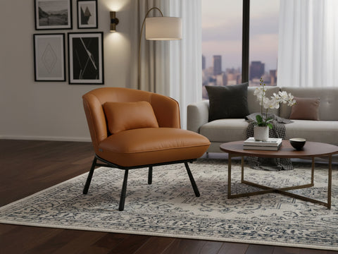 Fancyoni Cognac Leather Minimalist Accent Chair in modern living room setting with city view, plush cushions, and elegant design.
