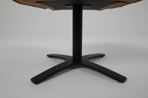 Close-up of the original Nero cognac leather chair base with the exact black five-spoke swivel legs.