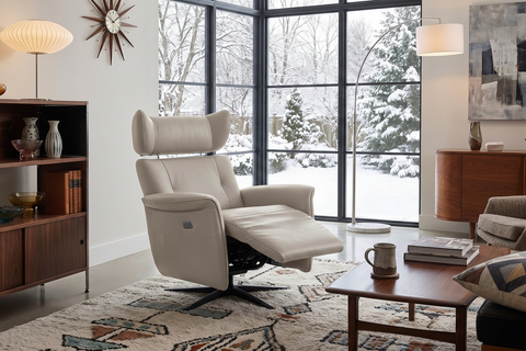 Neutral beige leather recliner chair in a styled living room