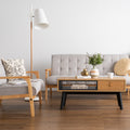 Living room with Lia Mid-Century Modern Oak Coffee Table with Drawer, Nordic style decor, wooden floor, and gray furniture.