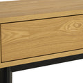 Close-up of Lia Mid-Century Modern Oak Coffee Table with Drawer, showing Nordic-inspired oak top and black angular legs.