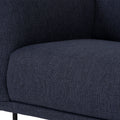 Close-up of Livia Navy Blue Firm Accent Chair with deep Linsey fabric and slender black metal legs, showcasing its contemporary design.