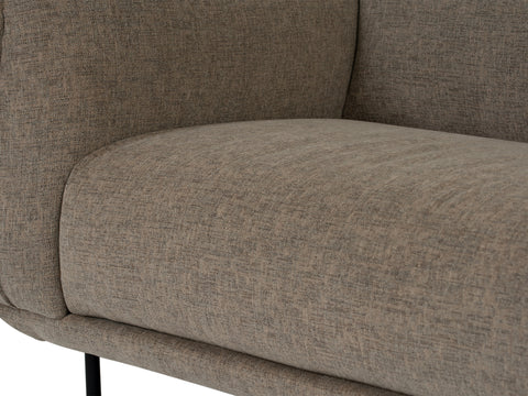 Close-up of Livia Beige Firm Accent Chair with Linsey fabric and black metal legs, showing soft lines and contemporary design.