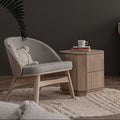 Lucca Modern Barrel Armless Chair in grey with wooden frame in a contemporary living room setting.