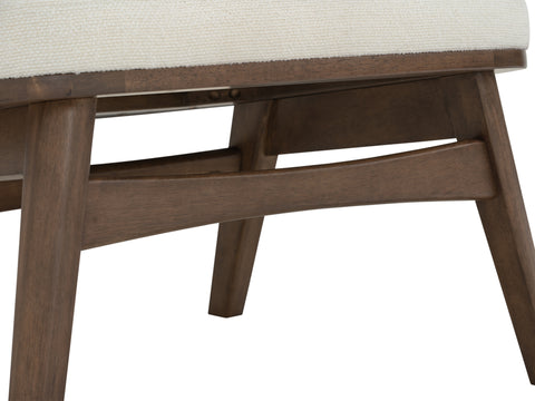 Close-up of wood frame and cream fabric on Lucca Modern Barrel Armless Chair