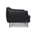 Lusso vintage black leather lounge chair showcasing elegant side design and premium craftsmanship.