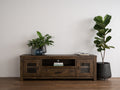 Mira Rustic TV Stand in dark wood with plants, showcasing a timeless, rustic design in a modern living space.