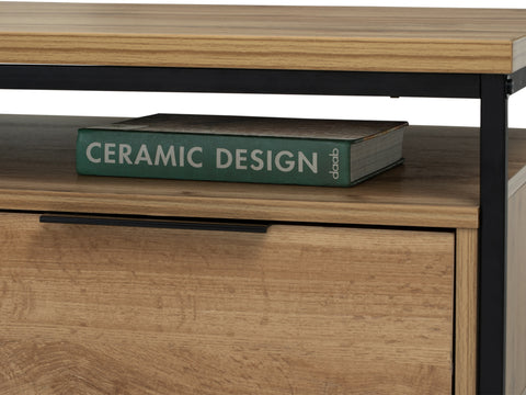 Close-up of Moda industrial Style Coffee Table with book on wooden shelf, showcasing wood-look laminate and black metal frame.