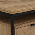 Moda industrial Style Coffee Table with wood-look laminated surface and black metal frame, featuring one of two drawers visible.