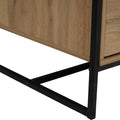 Close-up of a Moda industrial Style Coffee Table's wood-look laminated board and black metal frame.