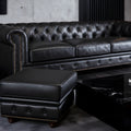 Stanhope Black Leather Chesterfield Ottoman in elegant modern living room setting, showcasing luxury and refined British design.
