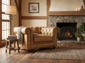 Stanhope Camel Brown Distressed Leather 1 Seater Chesterfield in cozy rustic room by fireplace.