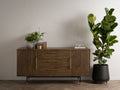 Nero Mid-Century Fluted Door Sideboard with Brass Handles in a modern minimalist setting with plants and books.