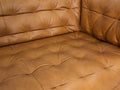 Close-up of the Nova Modern Chesterfield Tan Leather 3 Seater sofa, featuring rich tan leather and tufted detail.