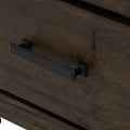 Close-up of the drawer handle on the Pia Rustic Bookcase - Dark Solid Wood featuring a sleek black metal pull on warm Oakaia wood finish.