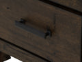 Close-up of the drawer handle on the Pia Rustic Bookcase - Dark Solid Wood featuring a sleek black metal pull on warm Oakaia wood finish.