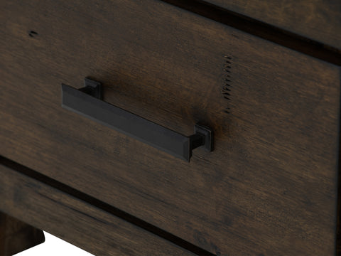 Close-up of the drawer handle on the Pia Rustic Bookcase - Dark Solid Wood featuring a sleek black metal pull on warm Oakaia wood finish.