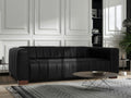 Portfino Vintage Black Channel tufted leather sofa in a stylish living room with modern decor.