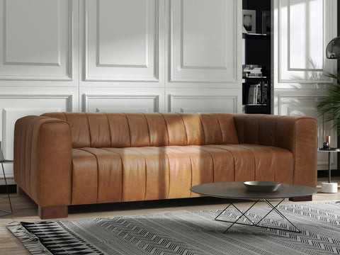 Portfino Vintage Brown Channel tufted leather sofa in a modern living room setting with elegant décor.