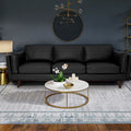 Selina Mid-Century Leather Black 3-Seater Sofa displayed in a modern living room setting with decorative elements.