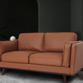 Selina Midcentury Brown Leather Loveseat Sofa in a contemporary living space with soft cushions and sleek design.