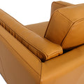 Selina Midcentury Cognac Leather Accent Chair showing top view of the luxurious leather upholstery and armrest design.