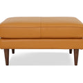 Selina Midcentury Cognac Leather Ottoman in plush cognac leather with teak oak legs, showcasing a modern yet classic style.