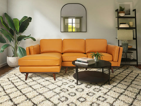 Selina Midcentury Cognac Leather Sectional Sofa in a modern living room setting with plants and stylish decor.