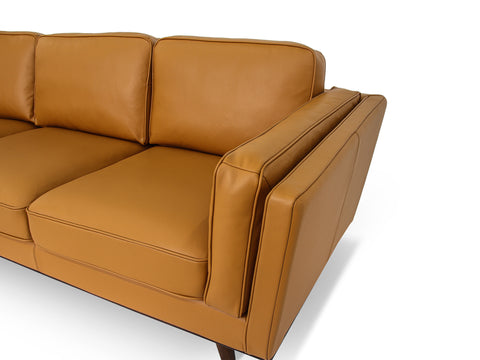 Selina Midcentury Cognac Leather Sectional Sofa side view showcasing plush seating and sleek design.