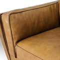 Selina Midcentury Tan Leather 3 Seater Sofa close-up of the cushion and armrest, showcasing the soft leather finish.