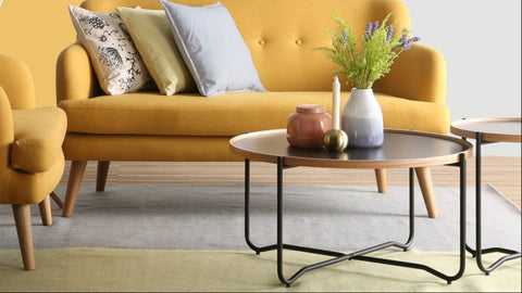 Siena Industrial Modern Coffee Table in contemporary living room setting with yellow sofa and decorative cushions