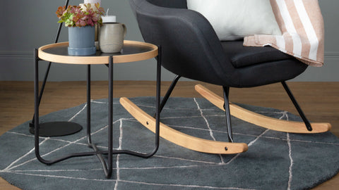 Siena Industrial Modern Side table with bentwood frame and steel legs beside a black chair on a geometric rug.