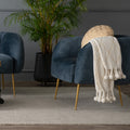 Modern living room with Soffio Glam Mid-Century Modern Velvet Accent Chair in blue velvet and gold legs, accented by plants and cozy decor.