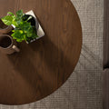Top view of Sogno Round Wood Top Metal Caged Base Coffee Table with plants and mugs, showcasing wood grain texture.