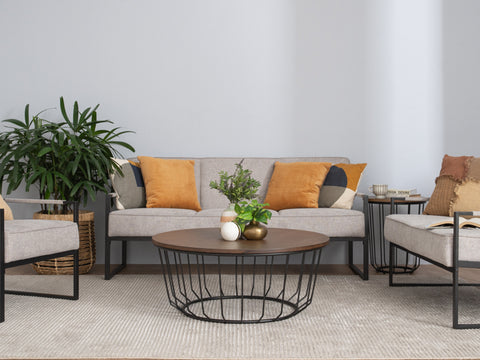 Sogno Round Wood Top Metal Caged Base Coffee Table in modern living room setting with plants and cushions.