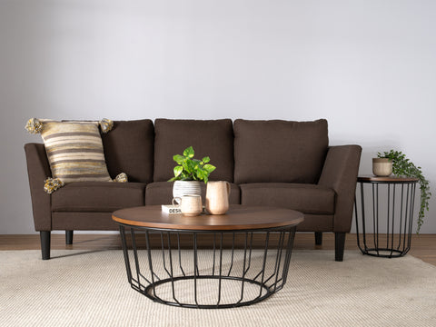 Living room scene with Sogno Round Wood Top Metal Caged Base Coffee Table in front of brown sofa and side table.