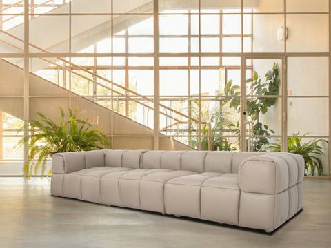 Tuscono Leather Beige 3 Seater Modular Sofa in modern interior setting with large windows and greenery.