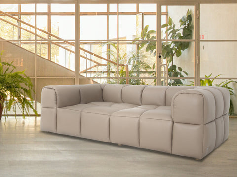 Tuscono Leather Beige Loveseat Modular Sofa in a modern interior setting with greenery.