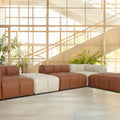 Tuscono Modular Leather Sofa in brown and beige, showcasing modern design and plush comfort in a spacious setting.